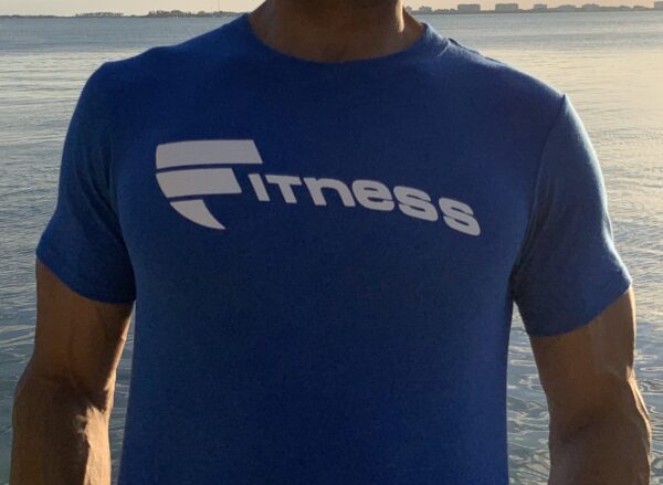 A man wearing a blue shirt with the word fitness on it.